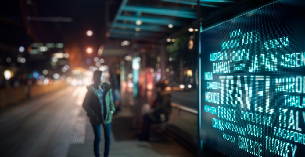 Digital signage at a bus stop after dark